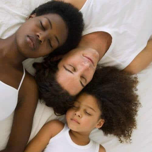 Photo of family sleeping peacefully together