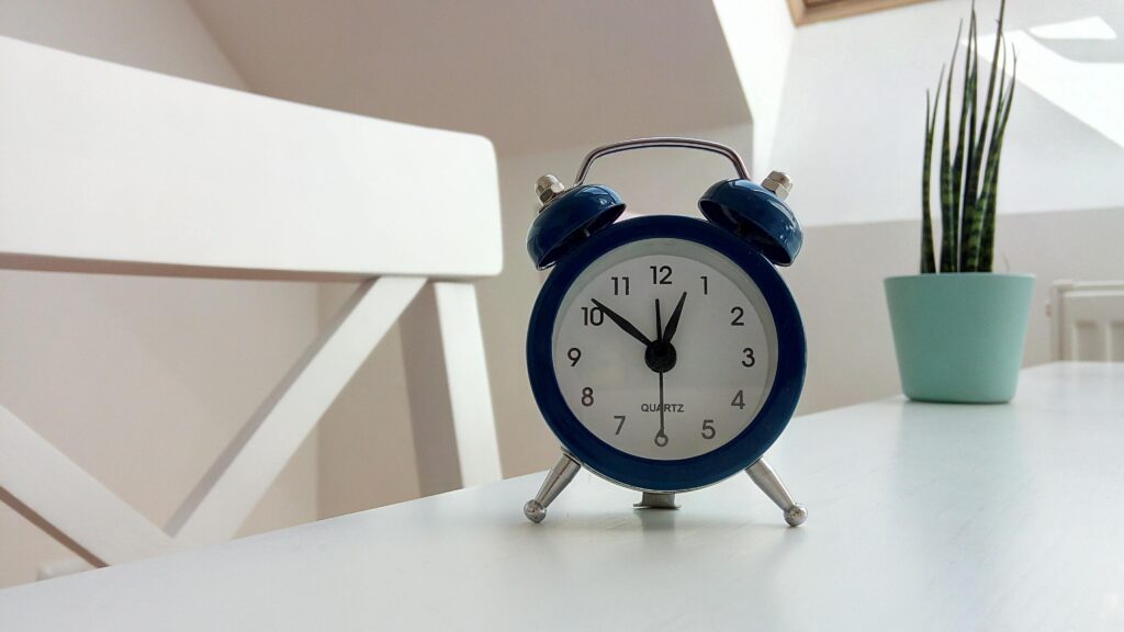 Alarm clock on desk. Placing an alarm clock away from your bed can help with waking up in the morning.