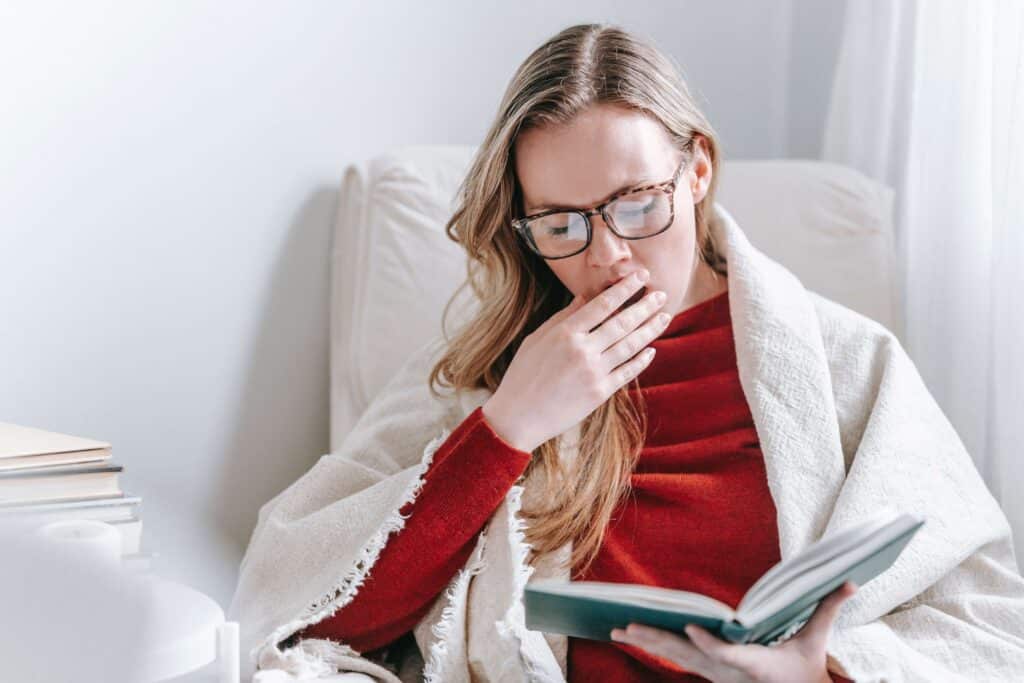 Woman yawning. Sleep deprivation can make waking up in the morning harder.